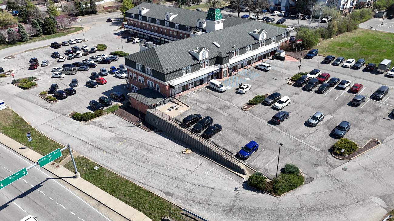 Clocktower corner of Three Flags Center with parking
